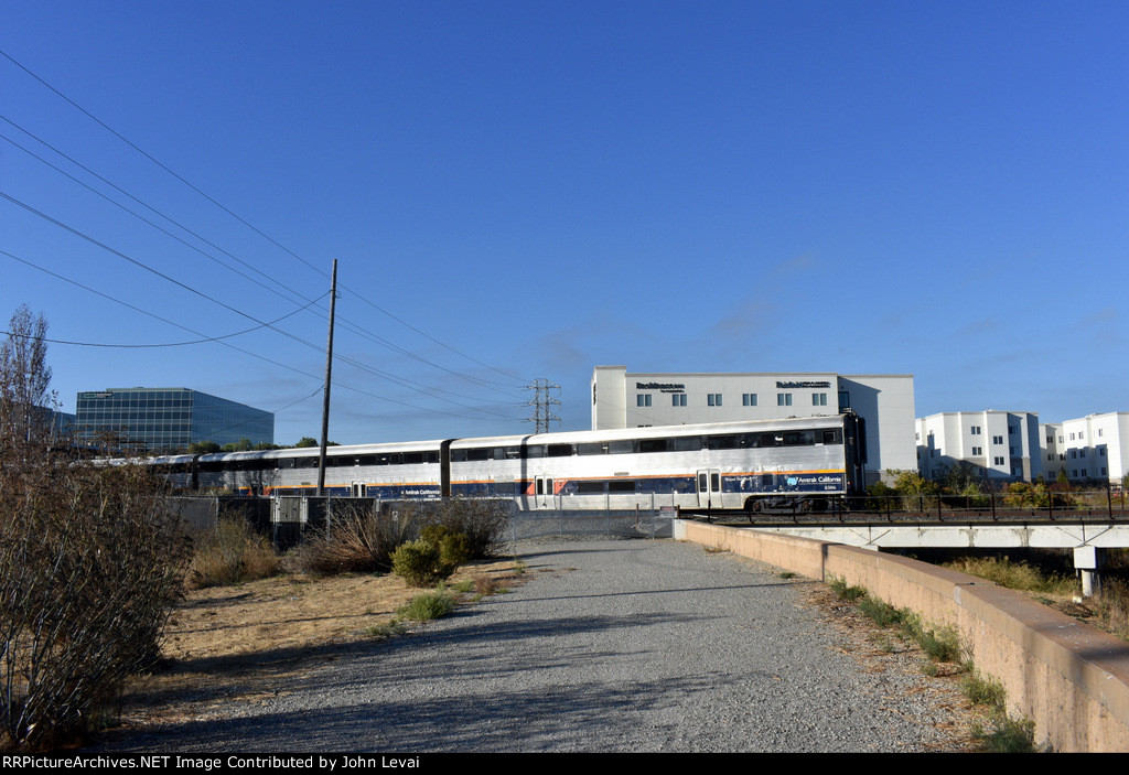 Amtrak Capitol Corridor Train # 528, being led by California Car # 8306, is about to cross the Guadalupe River Bridge, about a mile after departing from the Santa Clara/Great America Station 